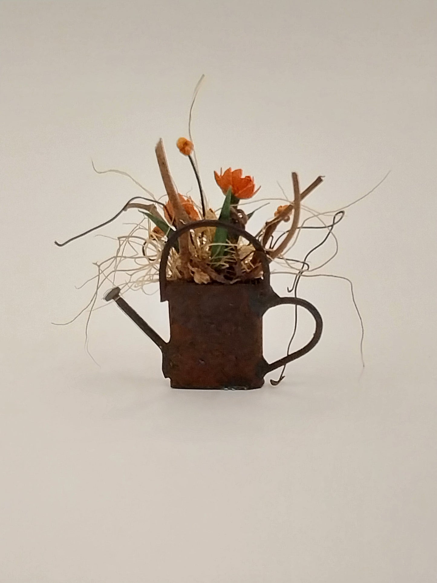 Floral Arrangement In Rusty Watering Can