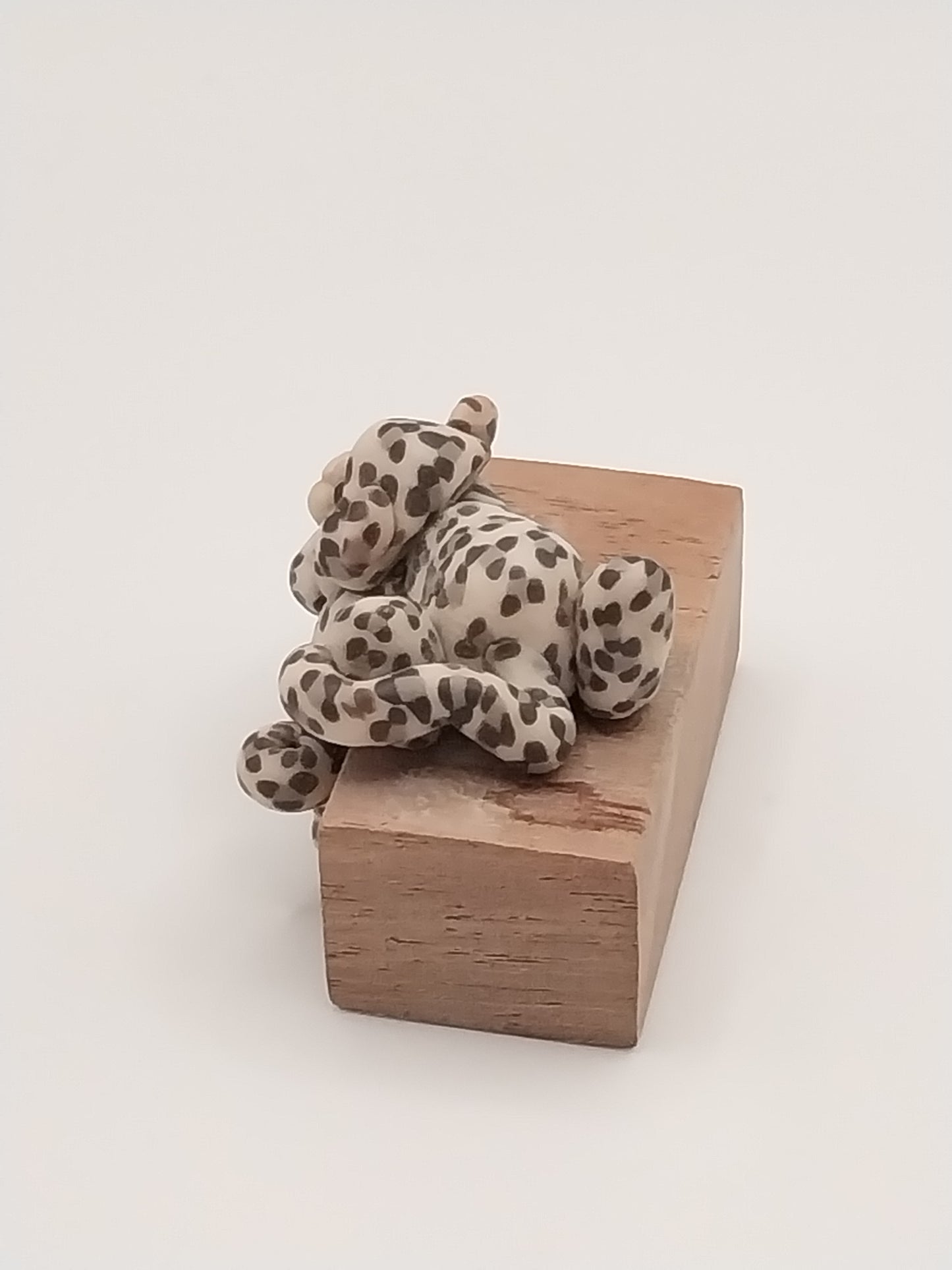Spotted Cat on Wooden Block