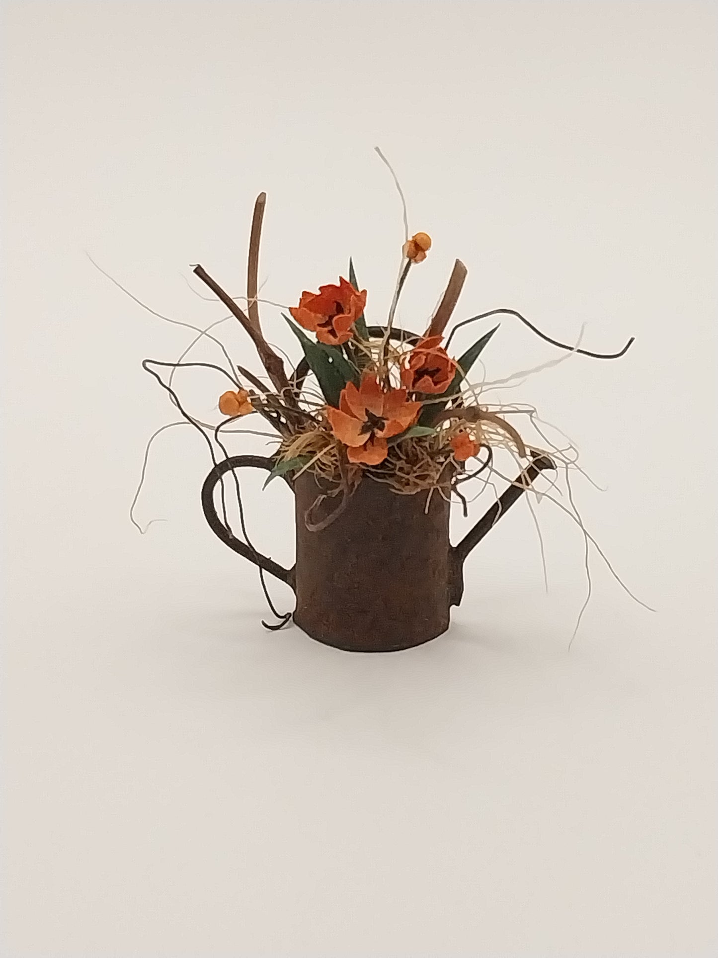 Floral Arrangement In Rusty Watering Can