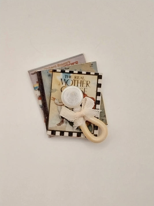 Stacked Mother Goose Books With Rattle
