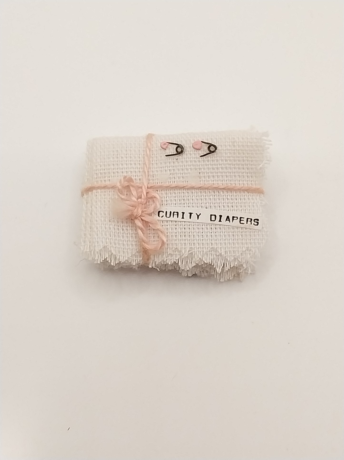 Stack Of Cloth Diapers With Pins