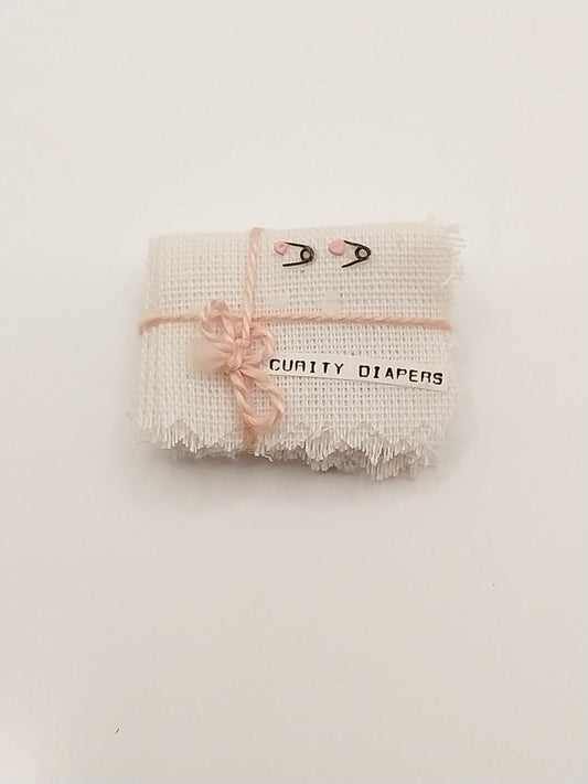 Stack Of Cloth Diapers With Pins