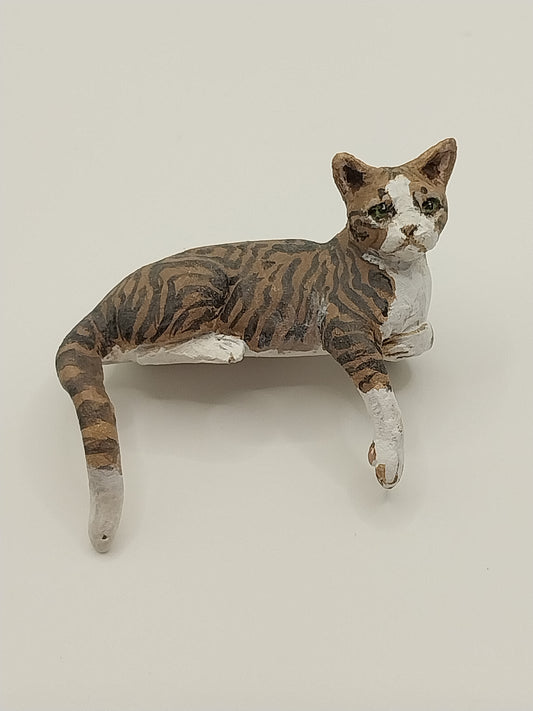 Mackeral Tabby Cat, Brown, Laying With Paw Down