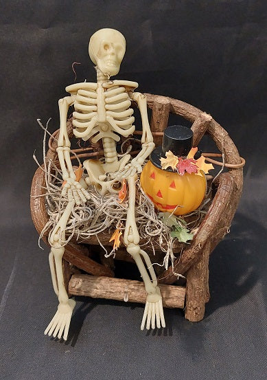 Skeleton on Bench with Pumpkin