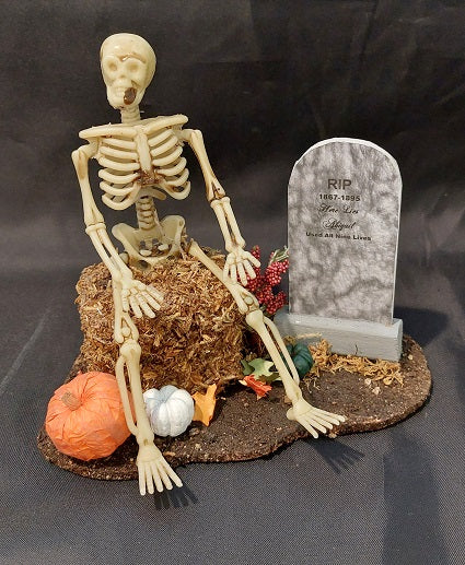 Skeleton on Hay with Tomb Stone