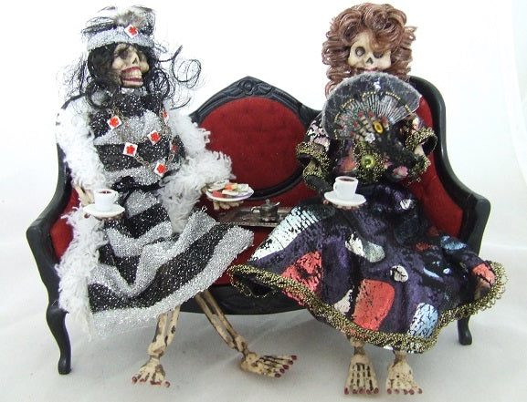 Skeleton Ladies on Red Couch